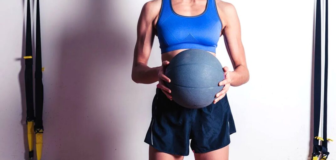 Woman In Gym Using Medicine Ball 1