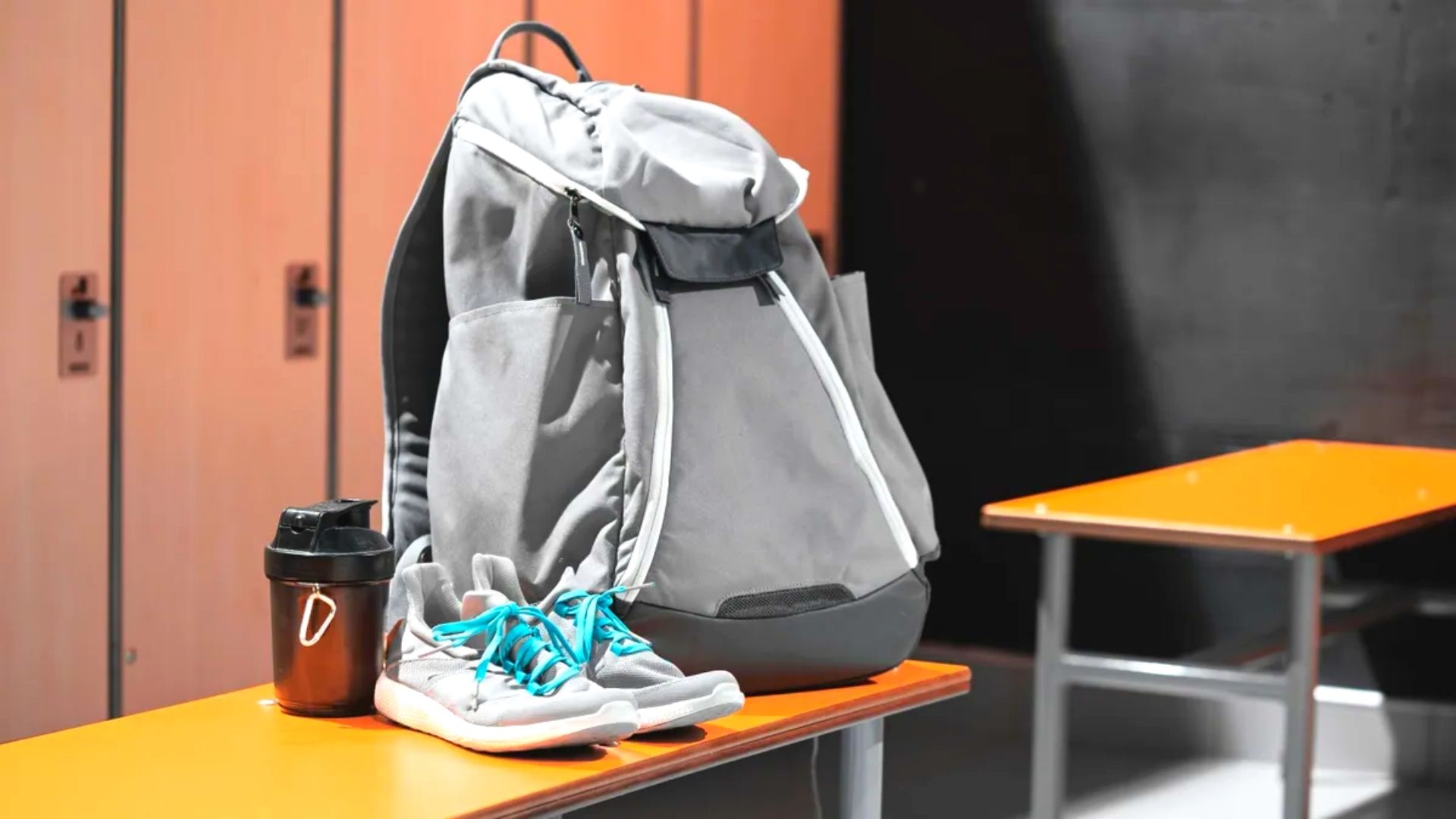 Gym Bag Sitting On Bench With Shoes And Protein Shaker