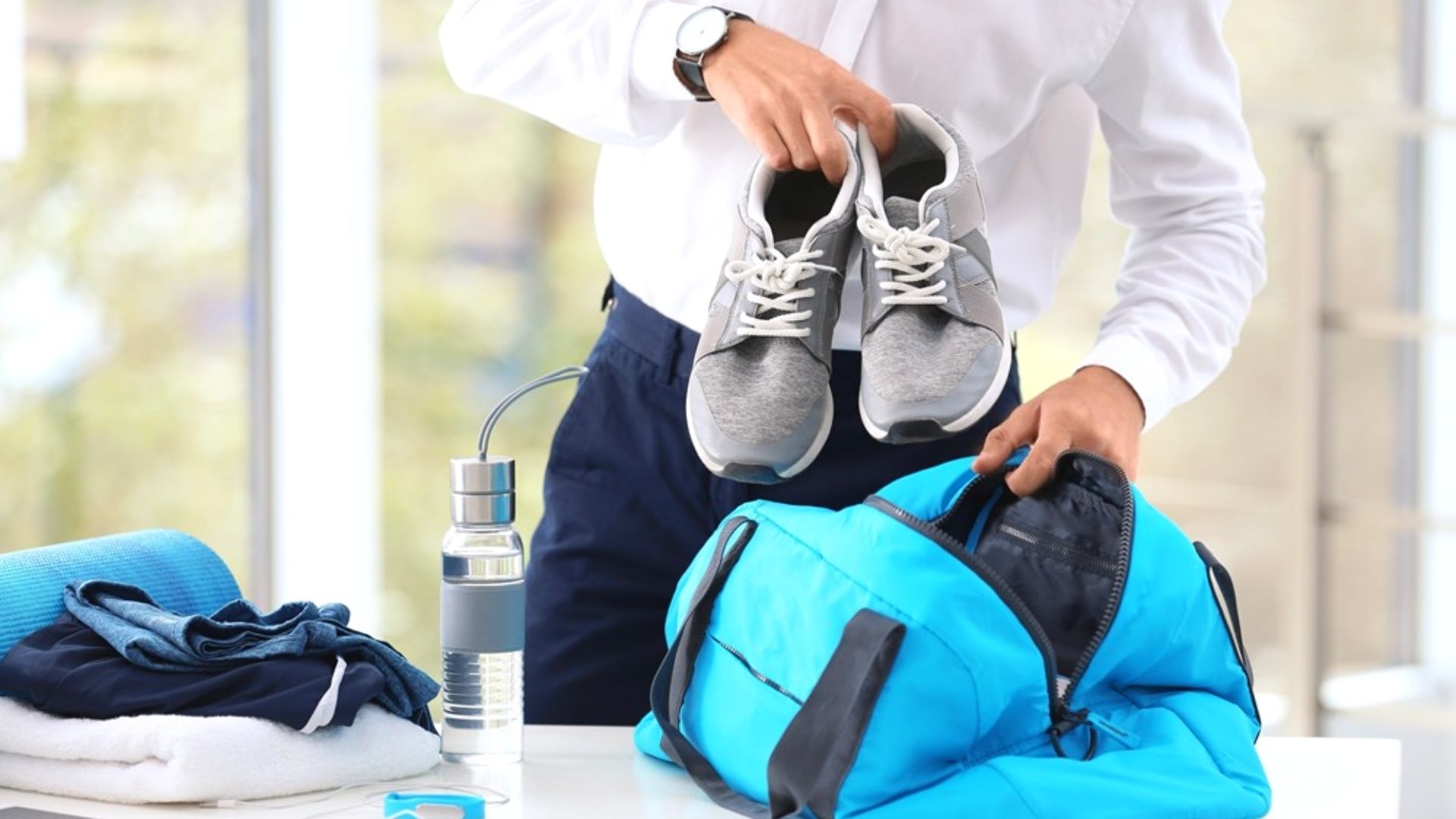Packing Shoes And Accessories Into Blue Gym Bag
