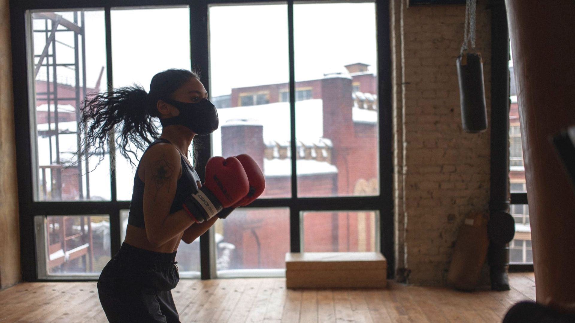 Heavy Bag Work Out Woman Wearing Mask And Red Gloves